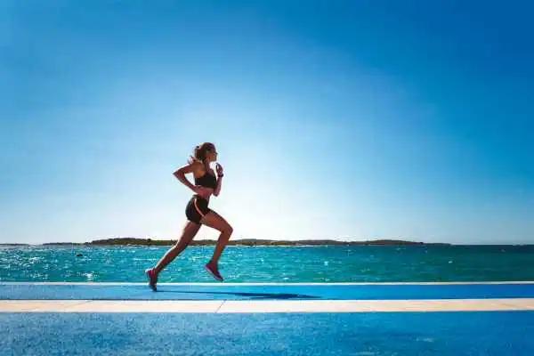 Woman running showing strong leg muscle Billericay